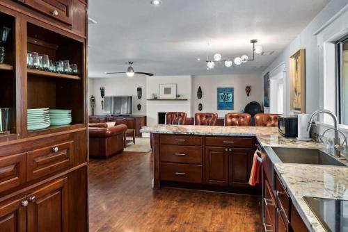 a kitchen with a counter top and a living room at Red Rock Retreat with Amazing Patio and Hot Tub for family in Sedona