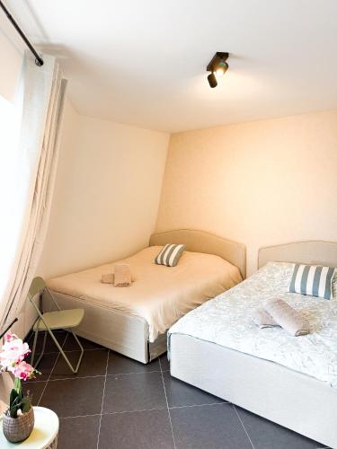 a bedroom with two beds in a room at COCO a unique quiet home with private parking in Laarne