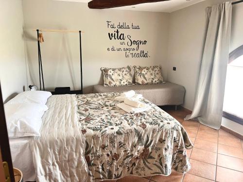 a bedroom with a bed and a couch at Cascina Santa Marta in Fossano