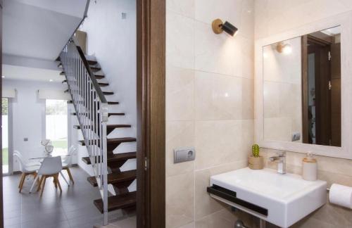a bathroom with a sink and a staircase at La Villa Dorada in Mojácar