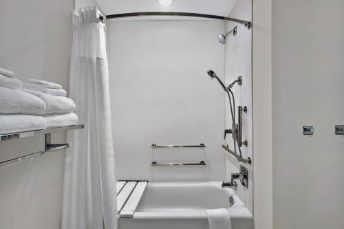 a white bathroom with a sink and a shower at Fairfield by Marriott Inn & Suites Orlando at FLAMINGO CROSSINGS® Town Center in Orlando
