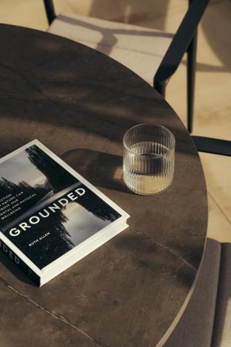 a table with a book and a cup on it at Hyll Hotel in Chipping Campden