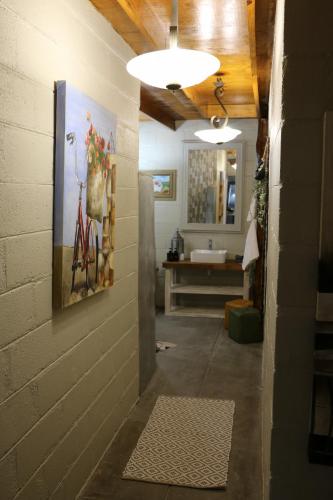 a hallway leading to a bathroom with a sink at Daisy Country Lodge in Springbok