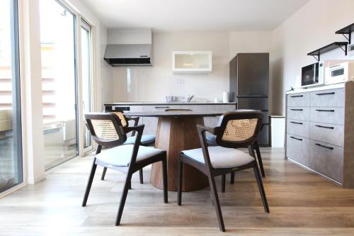 a kitchen with a table and chairs in a room at - YURAGI - TSUKI me CHILL in Oiwake