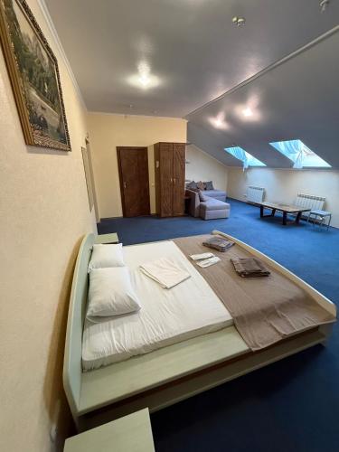 a bedroom with a large bed in a room at Sava Dream in Zhytomyr