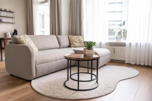 a living room with a couch and a table at City apartment in the centre of Enschede in Enschede