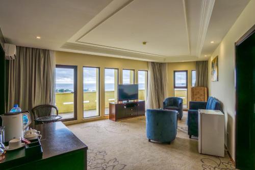 a hotel room with a room with a view of the ocean at Bintumani in Freetown