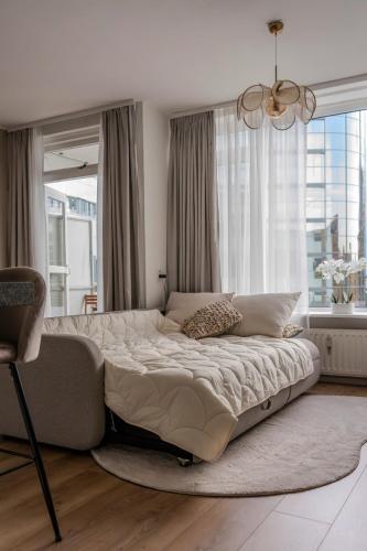 a bedroom with a large bed in front of a window at City apartment in the centre of Enschede in Enschede