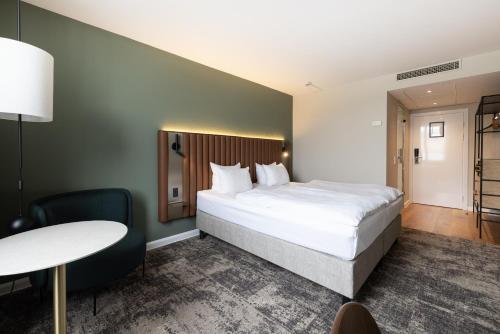 a hotel room with a bed and a table at Imperial Hotel in Copenhagen