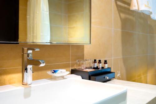 a bathroom with a sink and a faucet at Bintumani in Freetown