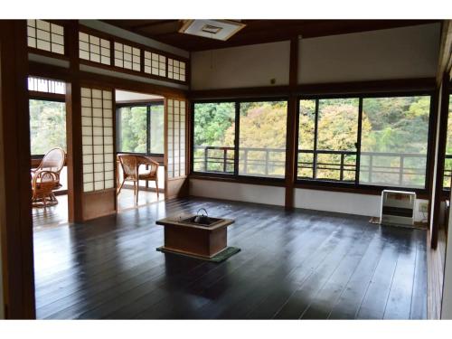 a room with a table in a room with windows at Kisuien - Vacation STAY 55464v in Kinokawa