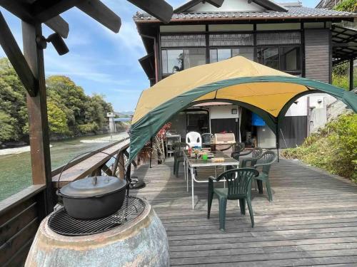 a deck with a grill and tables and chairs at Kisuien - Vacation STAY 55464v in Kinokawa