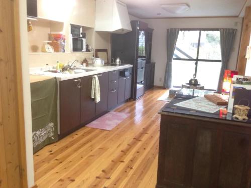 a kitchen with a wooden floor and a counter top at Kisuien - Vacation STAY 55464v in Kinokawa
