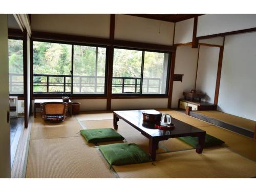 a living room with a table and a large window at Kisuien - Vacation STAY 55464v in Kinokawa