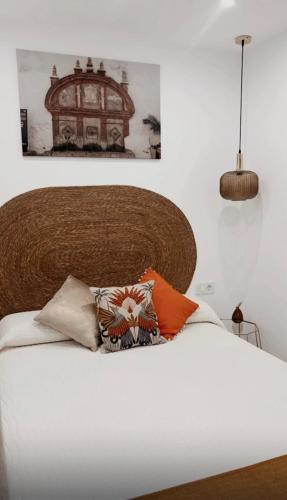 a bedroom with a large white bed with pillows on it at La morada de Rosafina in Frigiliana