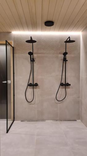 a room with three hangers on a wall at Villa Aureola in Pyhäjoki