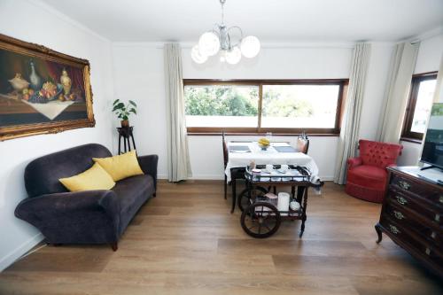 a living room with a couch and a table at A Côrte Das Azenhas in Valença