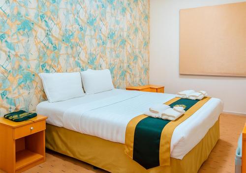 Katil atau katil-katil dalam bilik di Paradise Land Hotel Makkah