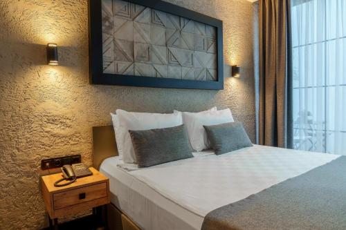 Ένα ή περισσότερα κρεβάτια σε δωμάτιο στο Mielo Lara Hotel