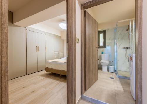 a bedroom with a bed and a bathroom with a shower at Azure Sofia - Grounded in Kos