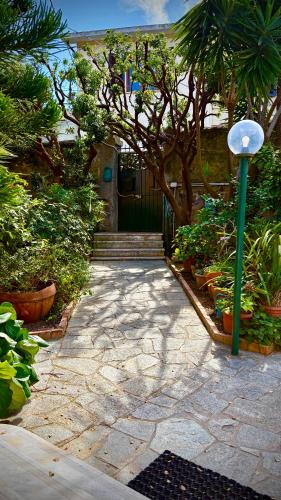 a door to a house with plants and a street light at Resort Dependance di Villa Rosa Maria in Savona