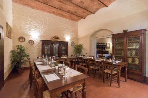 a large dining room with wooden tables and chairs at Relais Fattoria Valle in Panzano