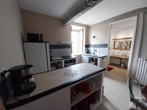 a kitchen with a counter top in a room at Grand logement 140m2 pour 6 personnes in Laguian-Mazoux