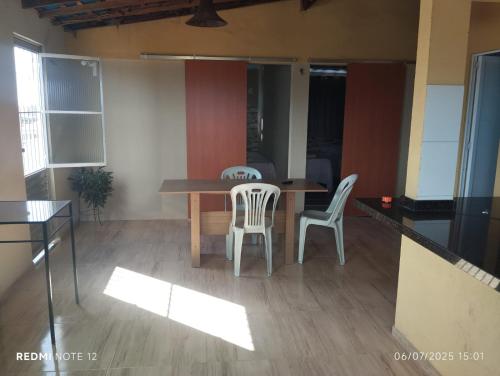 a dining room with a table and two chairs at Apartamento Avenida 31 in Barreirinhas