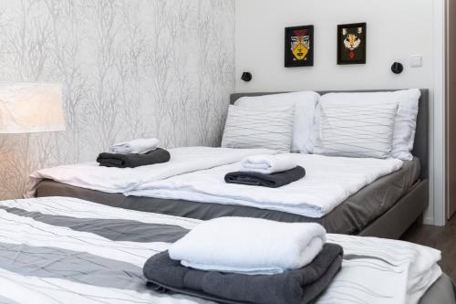 two beds in a room with towels on them at Cosy and Modern Apartment Labska Spindl in Krausovy Boudy