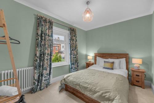 a bedroom with a bed and a window at Harrogate Heights - Luxury 6 Bed Central Harrogate Home in Harrogate