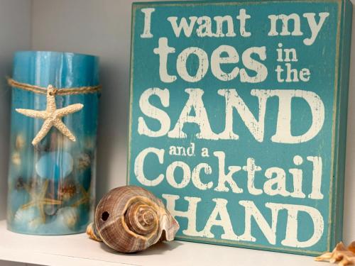 a book that says i want my toes in the sand and a coastal hand at Reflections 2bd2babalconypoolshottub-4pp in Lake Ozark