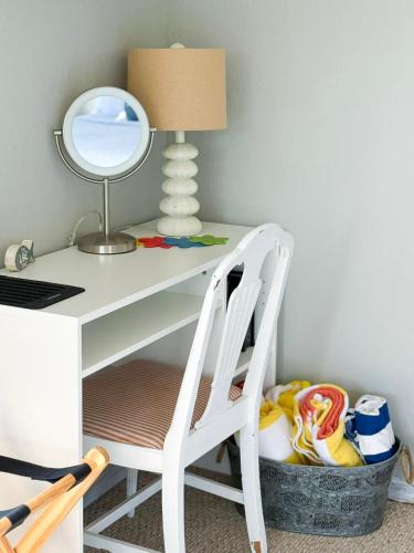 a desk with a chair and a lamp and a mirror at Reflections 2bd2babalconypoolshottub-4pp in Lake Ozark
