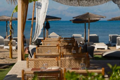 a group of chairs and tables on the beach at Argilos in Sidari