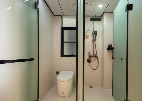 a bathroom with a toilet and a shower at 笑涡SmileNest Downtown Luxury Suite for 2-10 Guests, Zhangjiajie Attraction Ticket Service, Ideal for Couples, Families & Groups in Zhangjiajie