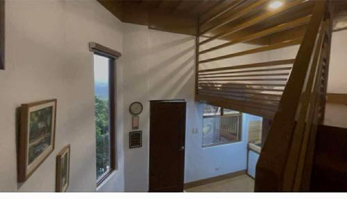 a hallway with a door and a clock on a wall at AVEYA Staycation in Tanay