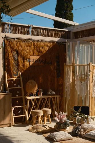 a patio with a table and some stools and a table and chairs at Argilos in Sidari