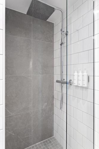 a shower with a glass door in a bathroom at Radisson Hotel Haugesund in Haugesund