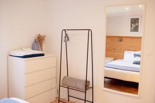 a bedroom with a mirror and a bed at Onda - Boutique Garden Ocean View Suite in the Countryside - Vila Pilar in Pilar