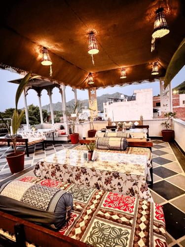 a patio with a bunch of carpets on a table at Hotel Kanak Niwas in Bedla