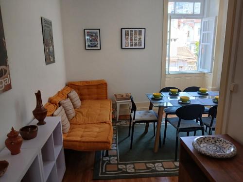 a living room with a couch and a table at AL Marias de Órion in Coimbra