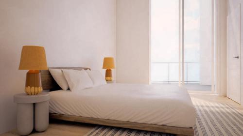 a bedroom with a bed with two lamps on it at Flow Brickell Hotel in Miami