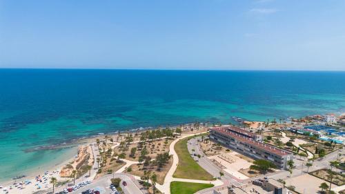 an aerial view of a beach and the ocean at 2BD Coastal Gem with Pool & Terrace - Torre de la Horadada in Torre de la Horadada