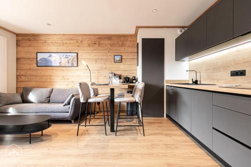 a kitchen and living room with a table and a couch at Résidence Cokott - 2 Pièces pour 4 Personnes MAE-2603 in Bessans