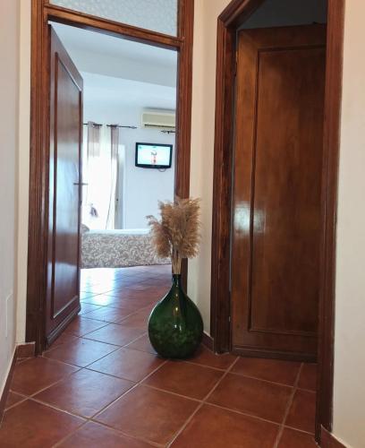 a vase with flowers sitting on a tile floor next to a door at Al Vicoletto in Fabrica di Roma