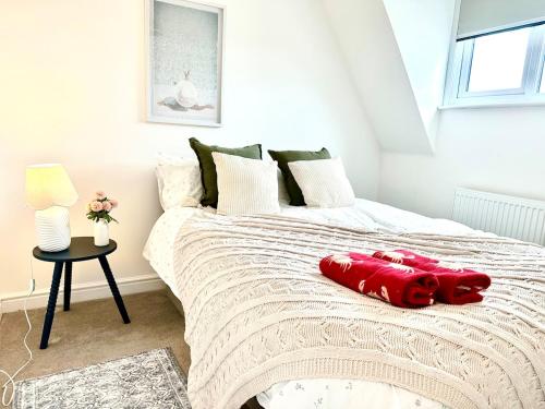 a bedroom with a bed with a red stuffed animal on it at New Five bed house with parking in St leonards in St. Leonards