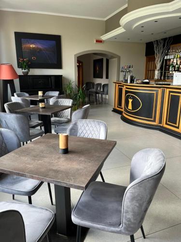 a restaurant with tables and chairs and a bar at Hotel Della Torre in Stresa