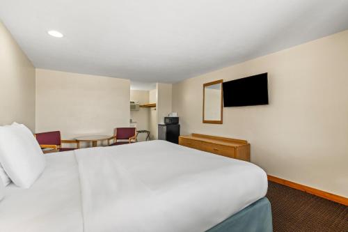 a hotel room with a bed and a table at Americas Best Value Inn Biddeford in Biddeford