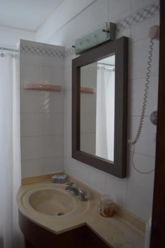 a bathroom with a sink and a mirror at Club Sol Mar Del Plata in Mar del Plata