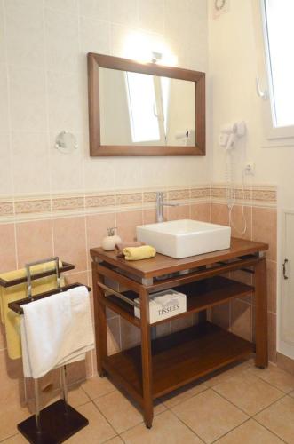 a bathroom with a sink and a mirror at Chambre d'hôtes au Domaine de la Moretie in Cublac