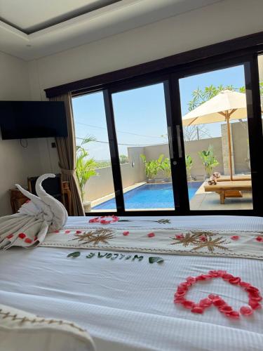 a bedroom with a bed with a swan decoration on it at Galatia Villa in Bukti